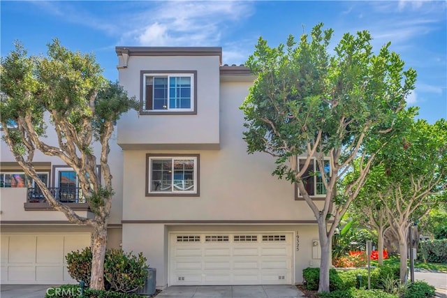 19325 Peachtree Ln, Huntington Beach, CA 92648 - view of front of house featuring an attached garage, stucco siding, and driveway
