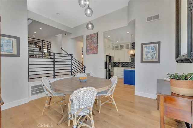 19325 Peachtree Ln, Huntington Beach, CA 92648 - dining room with stairway, light wood-style flooring, and recessed lighting