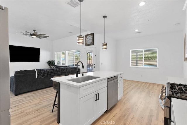12207 Snapping Turtle Rd, Apple Valley, CA 92308 - kitchen featuring stainless steel appliances, open floor plan, healthy amount of natural light, light wood finished floors, and recessed lighting