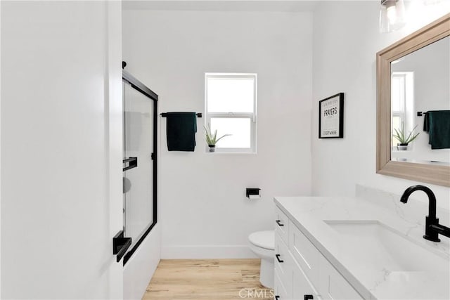 12207 Snapping Turtle Rd, Apple Valley, CA 92308 - full bath with vanity, plenty of natural light, wood finished floors, and bath / shower combo with glass door