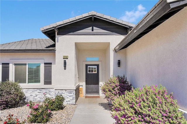 12207 Snapping Turtle Rd, Apple Valley, CA 92308 - property entrance featuring stucco siding, stone siding, and a tiled roof