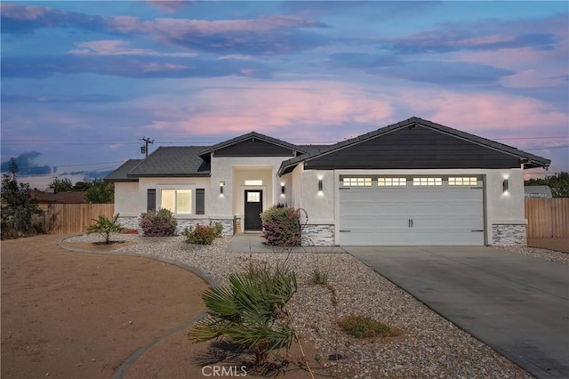 12207 Snapping Turtle Rd, Apple Valley, CA 92308 - ranch-style home featuring stone siding, concrete driveway, stucco siding, and a garage