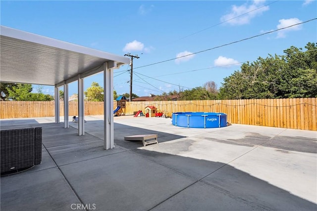 12207 Snapping Turtle Rd, Apple Valley, CA 92308 - fenced backyard featuring a playground and a patio area
