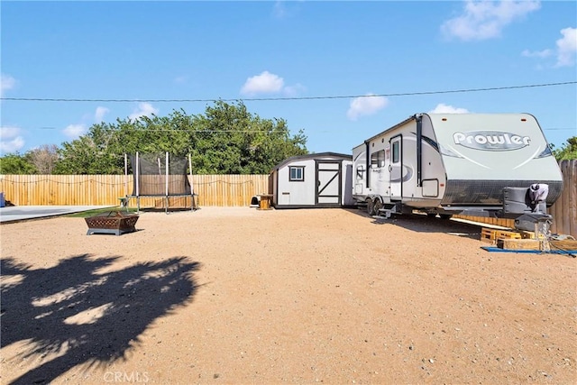 12207 Snapping Turtle Rd, Apple Valley, CA 92308 - fenced backyard with a trampoline and a storage unit