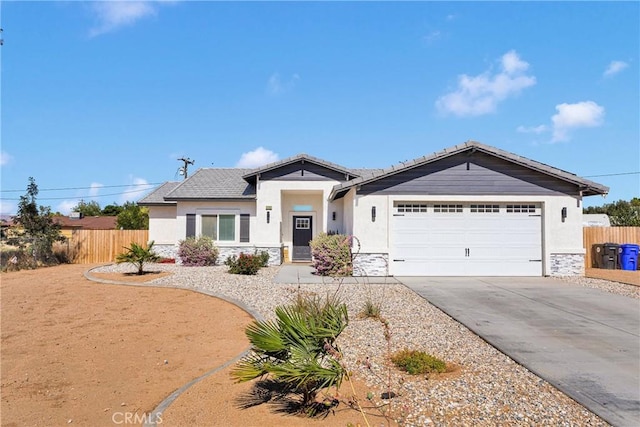12207 Snapping Turtle Rd, Apple Valley, CA 92308 - view of front of home featuring stone siding, driveway, a garage, and stucco siding