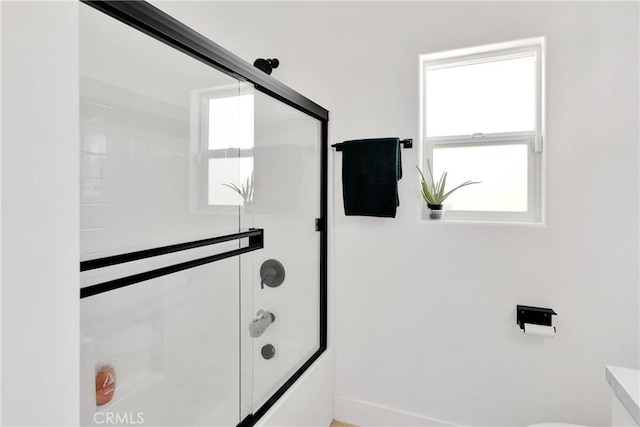 12207 Snapping Turtle Rd, Apple Valley, CA 92308 - bathroom featuring combined bath / shower with glass door and toilet