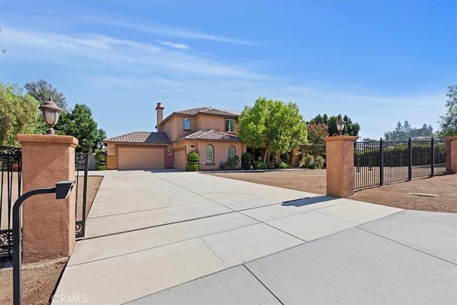 16858 Mariposa Ave, Riverside, CA 92504 - mediterranean / spanish-style house featuring an attached garage, driveway, stucco siding, and a tiled roof