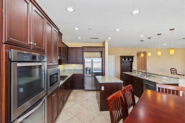 16858 Mariposa Ave, Riverside, CA 92504 - kitchen with stainless steel appliances, a center island, decorative light fixtures, recessed lighting, and under cabinet range hood
