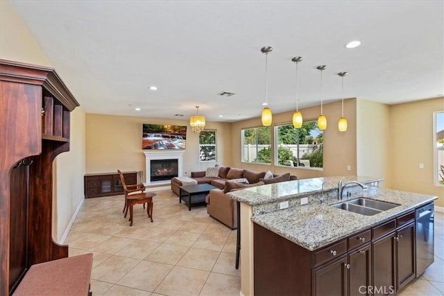 16858 Mariposa Ave, Riverside, CA 92504 - kitchen featuring dishwasher, light tile patterned flooring, a glass covered fireplace, pendant lighting, and recessed lighting