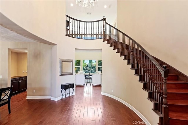 16858 Mariposa Ave, Riverside, CA 92504 - stairs featuring wood-type flooring, a chandelier, and a high ceiling