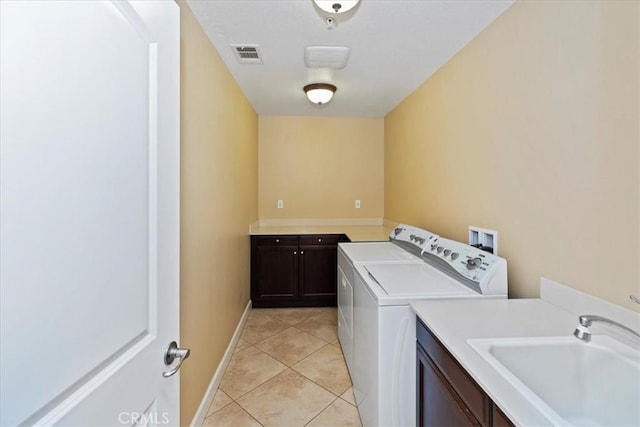 16858 Mariposa Ave, Riverside, CA 92504 - laundry room with cabinet space, washer and dryer, and light tile patterned flooring