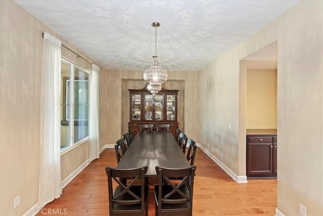 16858 Mariposa Ave, Riverside, CA 92504 - dining room featuring a chandelier and light wood-style floors
