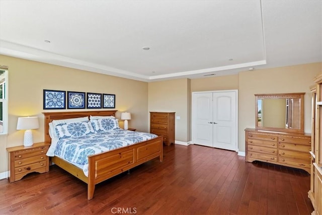 16858 Mariposa Ave, Riverside, CA 92504 - bedroom featuring a raised ceiling, dark wood-type flooring, and a closet