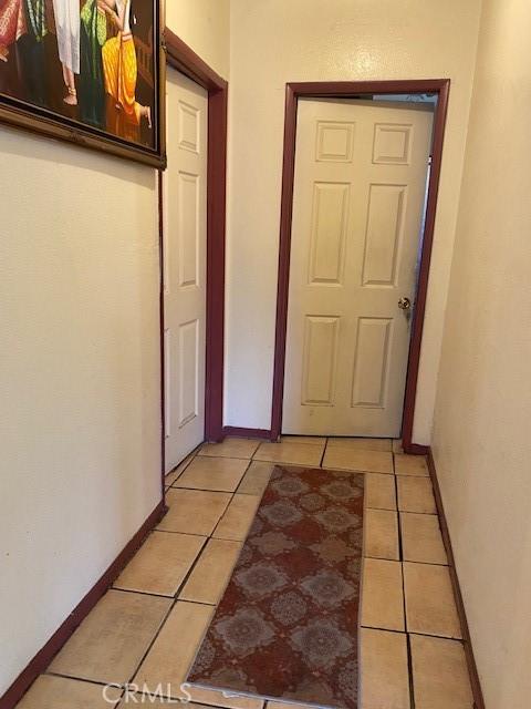 831 Alamitos Ave Unit 3, Long Beach, CA 90813 - hallway with light tile patterned flooring and baseboards