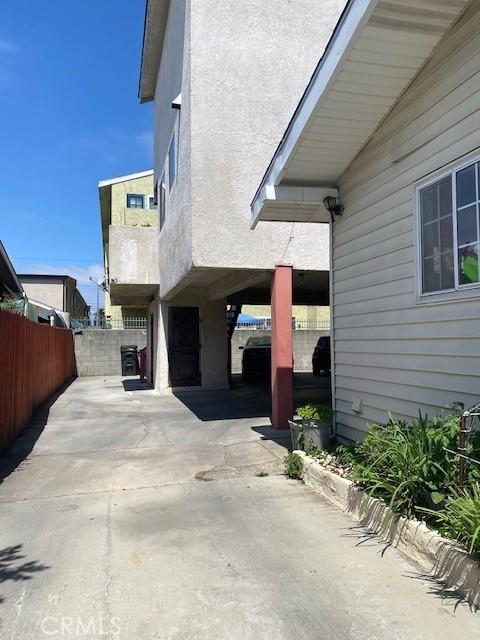 831 Alamitos Ave Unit 3, Long Beach, CA 90813 - view of side of property with a patio area, driveway, and stucco siding