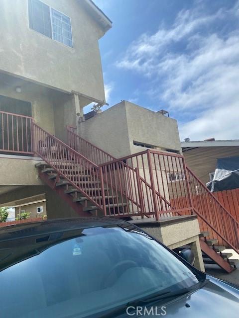 831 Alamitos Ave Unit 3, Long Beach, CA 90813 - view of home's exterior featuring stairway and stucco siding