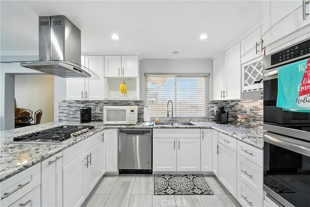 2007 Socrates Ave, Simi Valley, CA 93065 - kitchen featuring stainless steel appliances, island exhaust hood, backsplash, white cabinets, and light stone countertops