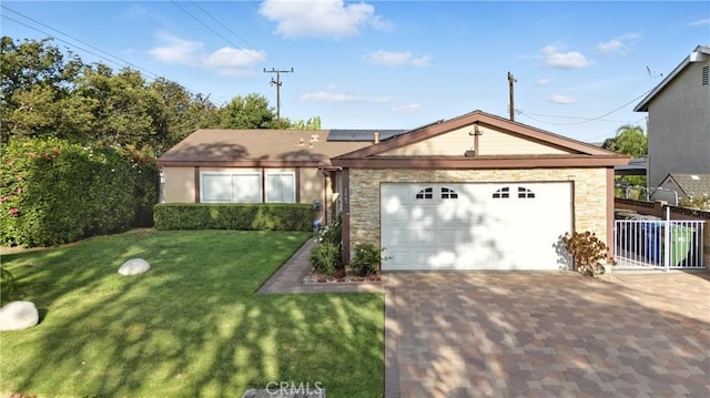 2007 Socrates Ave, Simi Valley, CA 93065 - ranch-style house featuring an attached garage, roof mounted solar panels, driveway, and stone siding
