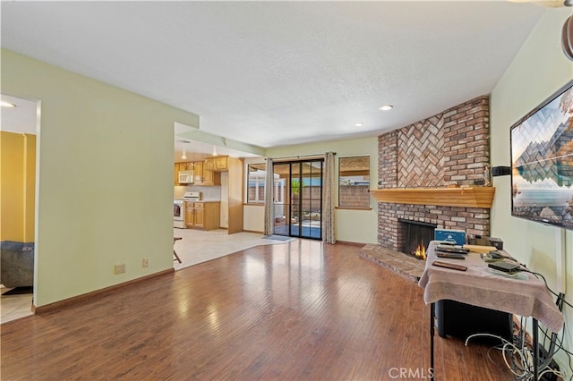 8038 Cyclamen Way, Buena Park, CA 90620 - living room with light wood-style floors, a fireplace, and recessed lighting