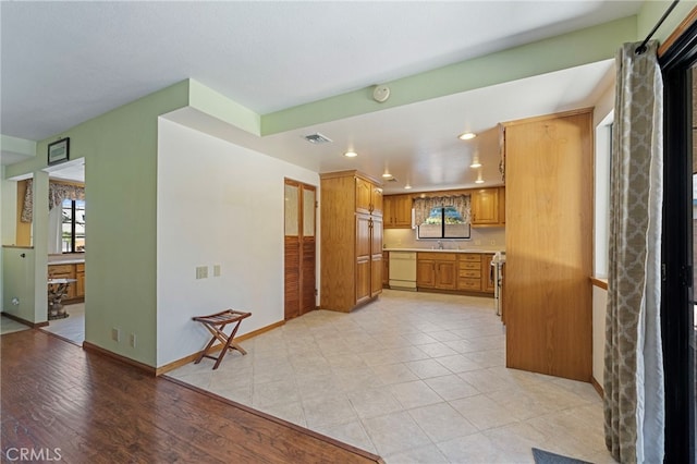 8038 Cyclamen Way, Buena Park, CA 90620 - kitchen with dishwasher, recessed lighting, light countertops, healthy amount of natural light, and brown cabinetry