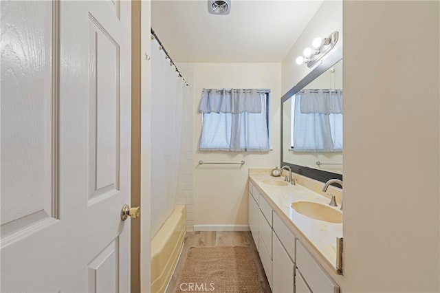 8038 Cyclamen Way, Buena Park, CA 90620 - bathroom with double vanity, shower / bathtub combination with curtain, and wood finished floors