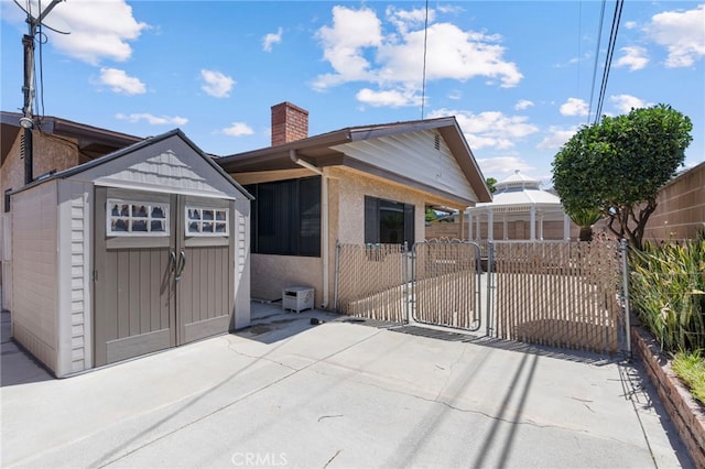 8038 Cyclamen Way, Buena Park, CA 90620 - view of front of house with a gate, a chimney, and a shed