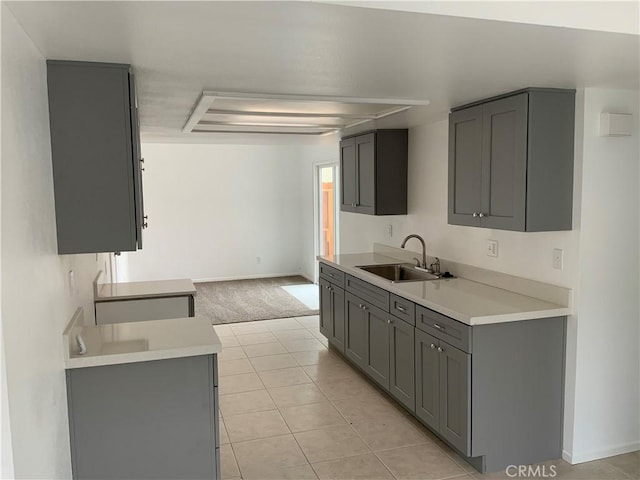 4839 Sanchez Dr, Guadalupe, CA 93434 - kitchen with gray cabinets, light countertops, light tile patterned flooring, and light colored carpet