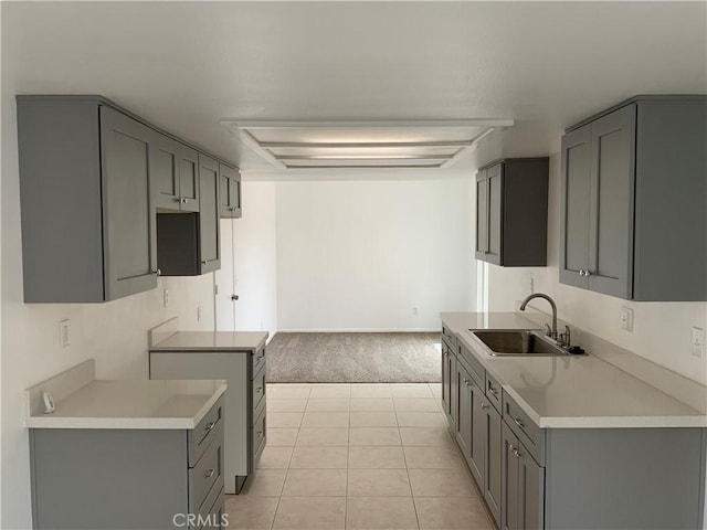 4839 Sanchez Dr, Guadalupe, CA 93434 - kitchen featuring gray cabinets, light colored carpet, light tile patterned floors, and light countertops