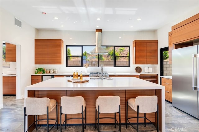 1922 Edgefair Ln, Redlands, CA 92373 - kitchen featuring modern cabinets, high end refrigerator, brown cabinets, island range hood, and light countertops