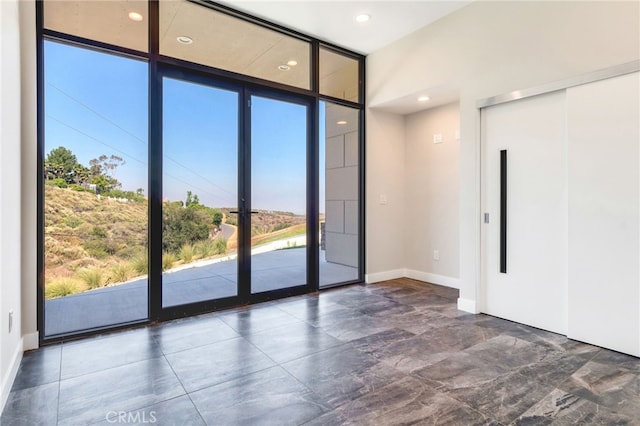 1922 Edgefair Ln, Redlands, CA 92373 - empty room with a wall of windows, recessed lighting, and elevator