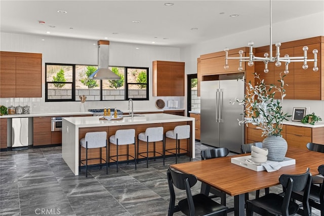 1922 Edgefair Ln, Redlands, CA 92373 - kitchen featuring high end fridge, modern cabinets, island range hood, brown cabinets, and recessed lighting