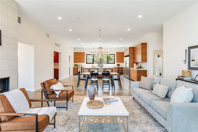 1922 Edgefair Ln, Redlands, CA 92373 - living room featuring a chandelier, recessed lighting, light wood-type flooring, and a tile fireplace