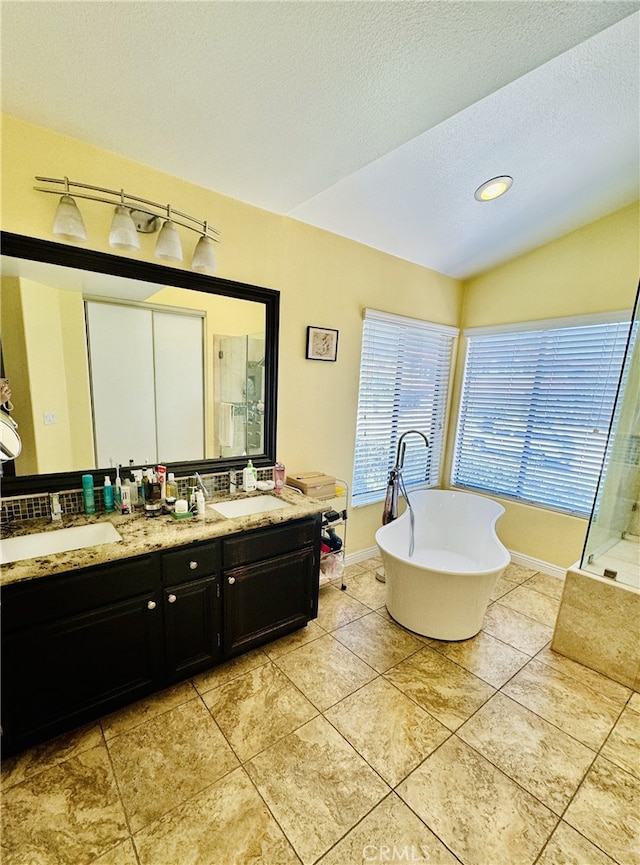 6159 Fleetwood Ln, Chino Hills, CA 91709 - bathroom with a stall shower, double vanity, a freestanding tub, tile patterned flooring, and a textured ceiling