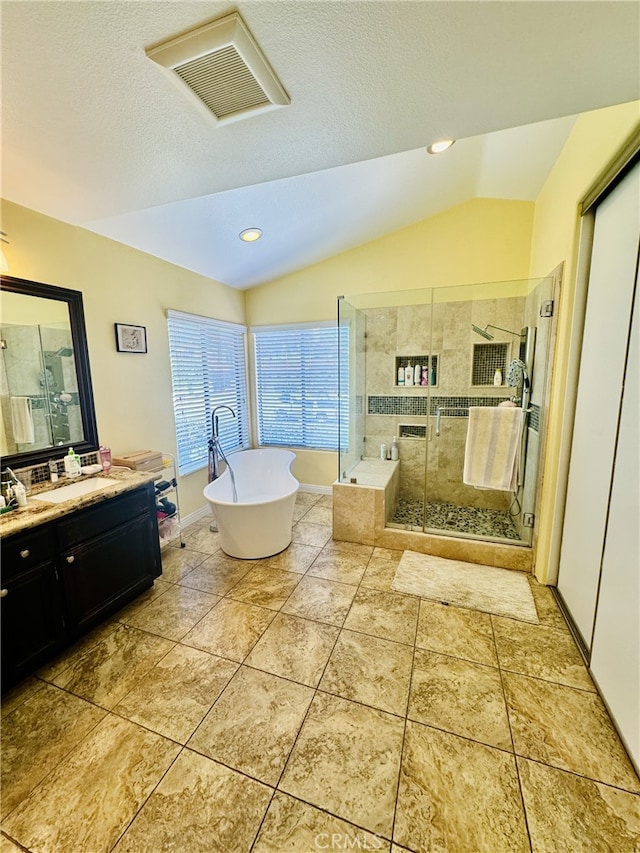 6159 Fleetwood Ln, Chino Hills, CA 91709 - full bathroom featuring lofted ceiling, vanity, a shower stall, a freestanding tub, and a textured ceiling
