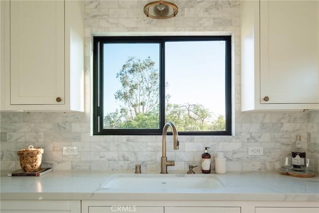 1830 N Alvarado St Unit 14, Los Angeles, CA 90026 - kitchen featuring white cabinetry, decorative backsplash, light stone counters, and plenty of natural light