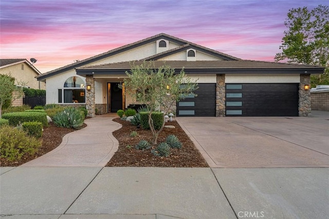 810 E Dalton Ave, Glendora, CA 91741 - view of front of house with driveway, an attached garage, stone siding, and stucco siding
