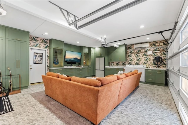 810 E Dalton Ave, Glendora, CA 91741 - living room featuring independent washer and dryer, a garage, recessed lighting, an AC wall unit, and wallpapered walls