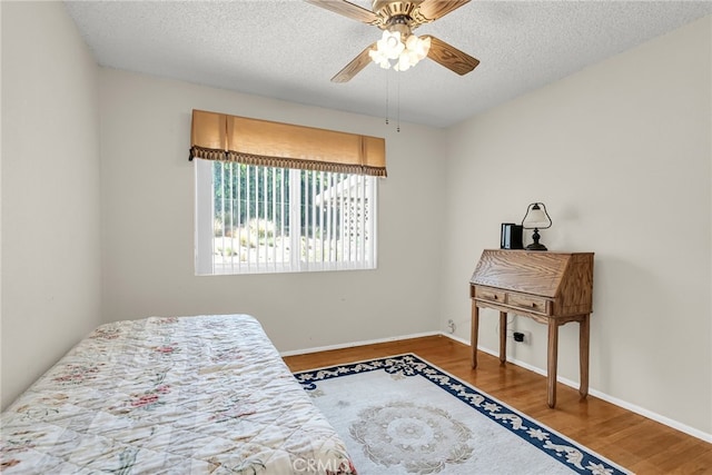 7219 Font Ave, Jurupa Valley, CA 92509 - bedroom featuring wood finished floors, a textured ceiling, and ceiling fan