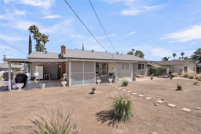 7219 Font Ave, Jurupa Valley, CA 92509 - rear view of house with a patio area, stucco siding, and a chimney