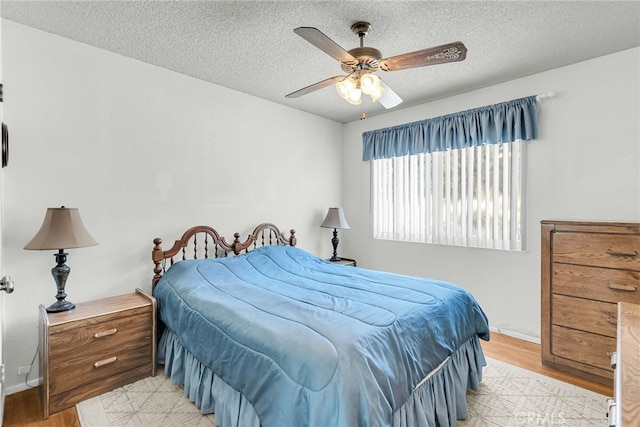 7219 Font Ave, Jurupa Valley, CA 92509 - bedroom with light wood-type flooring, a textured ceiling, and a ceiling fan