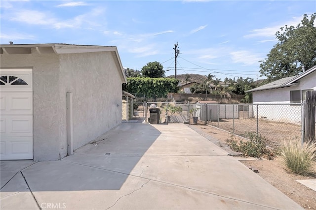 7219 Font Ave, Jurupa Valley, CA 92509 - view of side of property featuring stucco siding and a gate