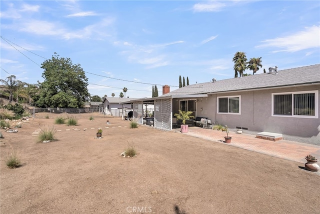 7219 Font Ave, Jurupa Valley, CA 92509 - back of house featuring stucco siding, a patio, and a chimney