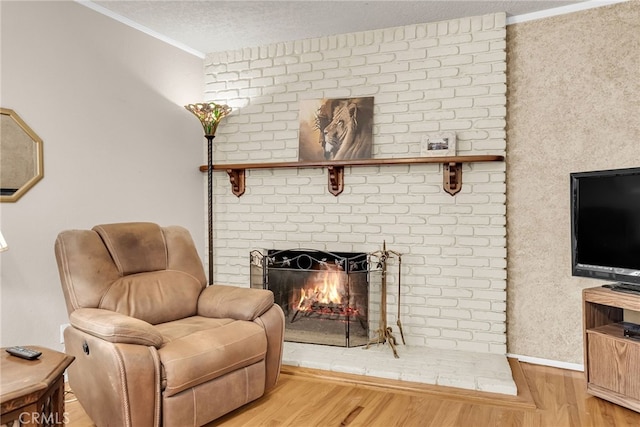 7219 Font Ave, Jurupa Valley, CA 92509 - sitting room with wood finished floors, crown molding, a brick fireplace, and a textured ceiling