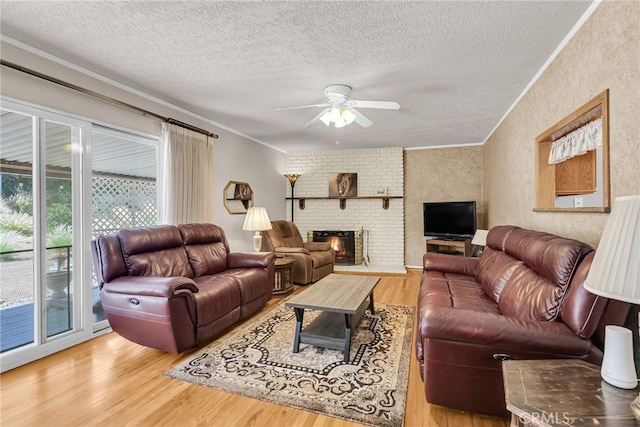 7219 Font Ave, Jurupa Valley, CA 92509 - living area with a textured ceiling, crown molding, ceiling fan, wood finished floors, and a fireplace