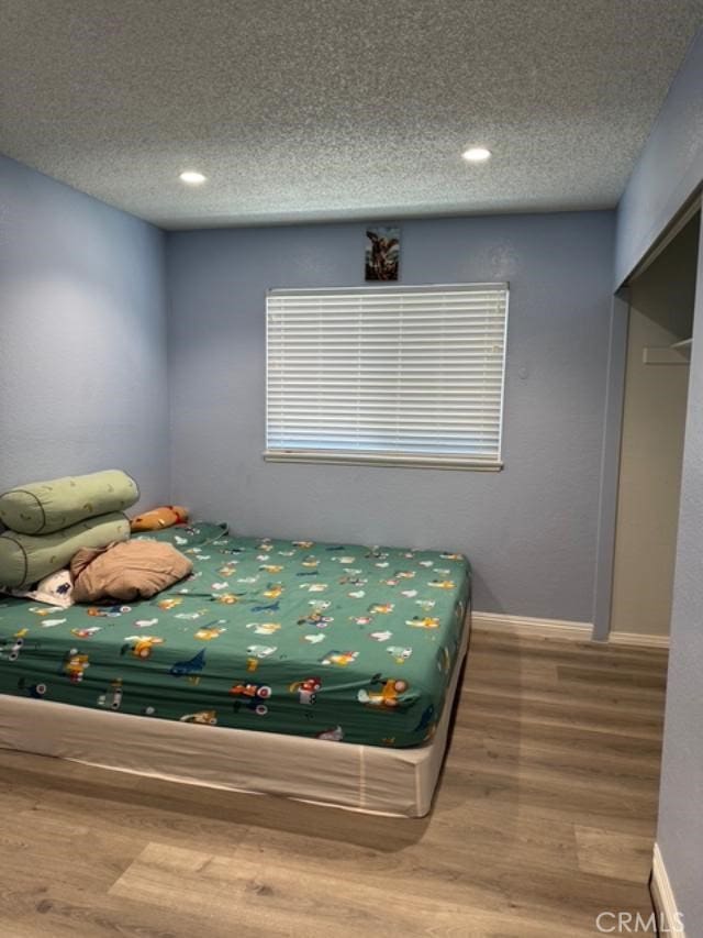 3629 Puente Ave, Baldwin Park, CA 91706 - bedroom with a textured ceiling, wood finished floors, and recessed lighting