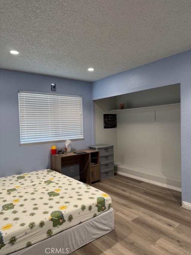 3629 Puente Ave, Baldwin Park, CA 91706 - bedroom with wood finished floors, recessed lighting, and a textured ceiling