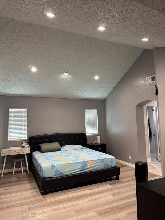 3629 Puente Ave, Baldwin Park, CA 91706 - bedroom featuring arched walkways, a textured ceiling, wood finished floors, recessed lighting, and vaulted ceiling