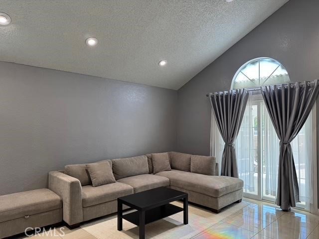 3629 Puente Ave, Baldwin Park, CA 91706 - living area with a textured ceiling, lofted ceiling, and recessed lighting