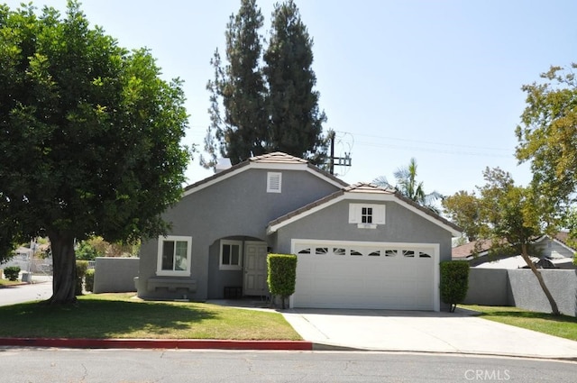 3629 Puente Ave, Baldwin Park, CA 91706 - view of front of property with driveway, a garage, stucco siding, and a front yard
