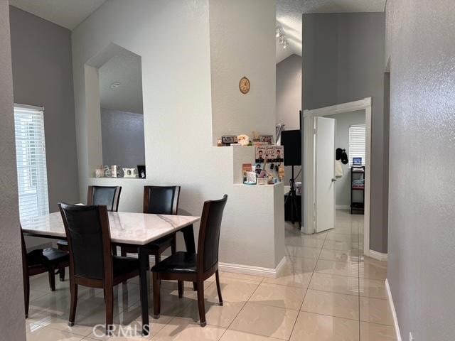 3629 Puente Ave, Baldwin Park, CA 91706 - dining room featuring high vaulted ceiling and baseboards
